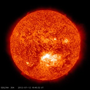 This image from the Solar Dynamics Observatory (SDO) shows the sun at 12:45 PM EDT on July 12, 2012 during an X1.4 class flare. The image is captured in the 304 Angstrom wavelength, which is typically colorized in red and shows temperatures in the 50,000 Kelvin range.